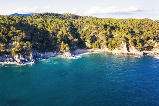 coastline with rocks, virgin beaches and sea cliffs covered with trees and vegetation, concept of adventure lifestyle and water sports in summer holidays