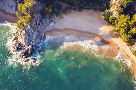 top view of a cove of turquoise waters surrounded with rock cliffs, trees and vegetation, concept of adventure lifestyle and summer holidays in the wilderness
