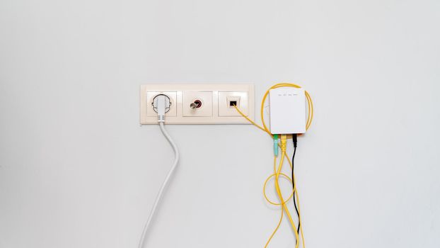 Socket with tangled wires, cables and Internet router on a white background. High quality photo