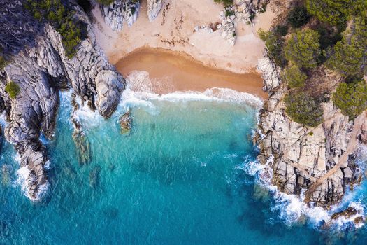 top view of a cove of turquoise waters surrounded with rock sea cliffs covered with trees and vegetation, concept of adventure lifestyle and summer luxury holidays in the wilderness