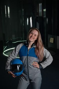 Caucasian woman puts on a helmet before flying in a wind tunnel. Free fall simulator