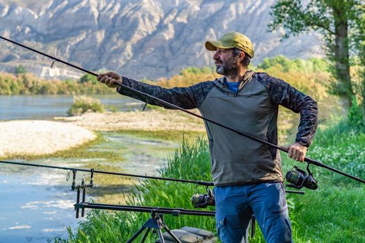 fishing session in the ebro river adult man with beard carp fishing