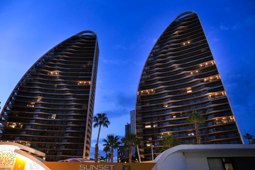 Benidorm, Alicante, Spain- September 11, 2022: Modern architecture buildings called Sunset Waves on the Poniente Beach Area in Benidorm at night