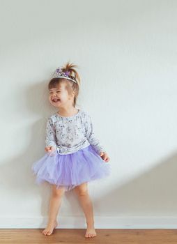 Charming child dancing at home. Space for text.