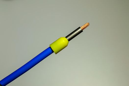 Blue wire with yellow ferrule - macro photo. Background picture. Selective focus. High quality photo