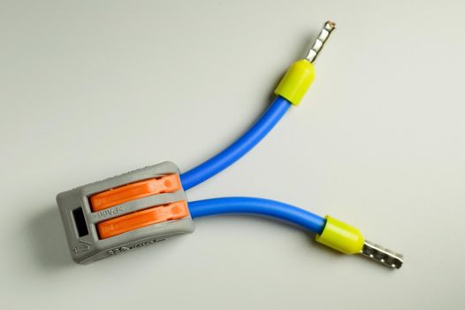 Electrical terminal for quick connection of wires with connected blue wires with yellow ferrules - macro photo. High quality photo