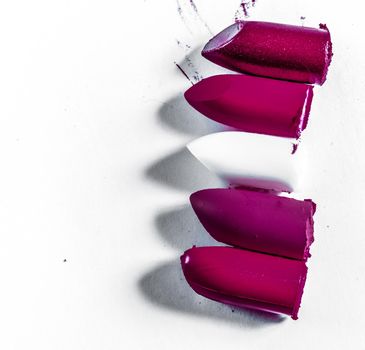 Beauty texture, cosmetic product and art of make-up concept - Cutted lipstick close-up isolated on white background