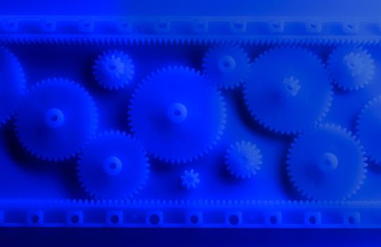 Plastic gears compilation on a neon blue background. Spare parts for your RC toy. Background picture. Sharp image.