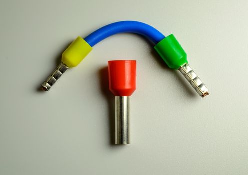 Blue cable with yellow and green ferrules and big red ferrule in the middle of composition. High quality photo