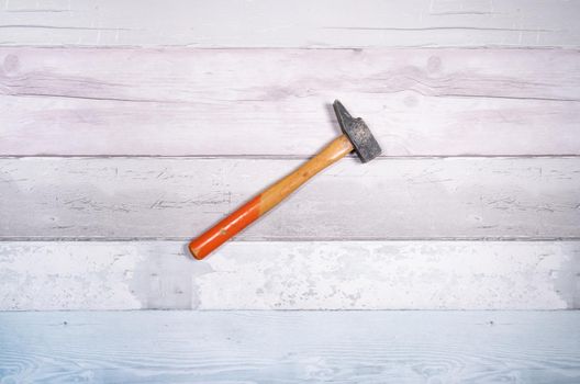 Carpenter's hammer on a background of old boards. Top view.