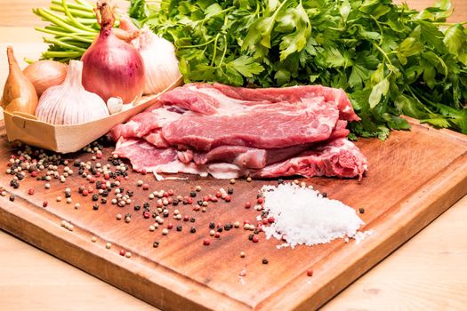 Raw pork ribs in the loin on a wooden board