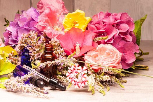 flowers and bottles of essential oils for aromatherapy