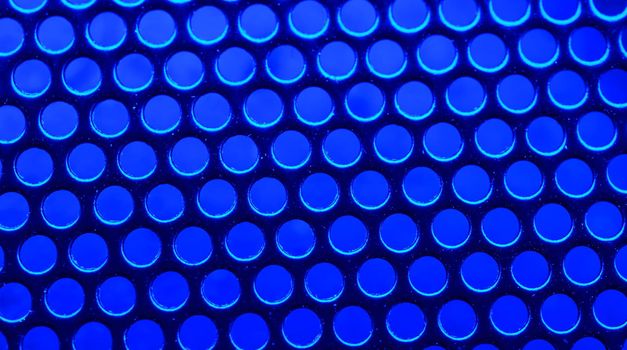 Metallic mesh under the neon blue light - macro photo. Background picture. High quality photo