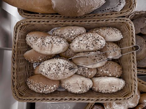 Delicious buns are on the table in a wicker basket. Top view, close-up.