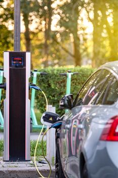 Charging modern electric vehicles at a street station. The process of charging an electric car