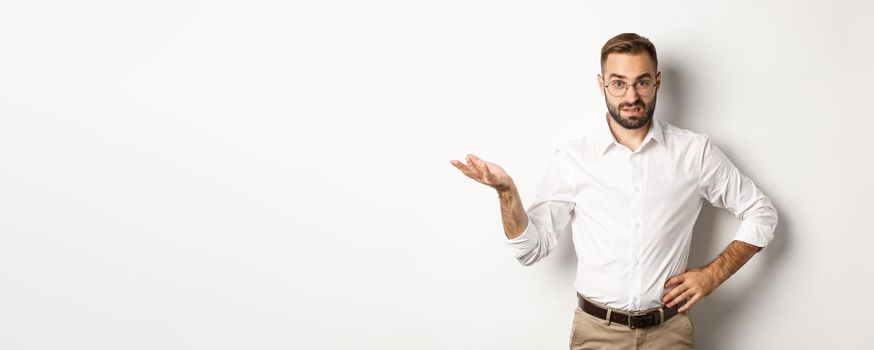 Confused office worker shrugging, cant understand something, standing over white background.