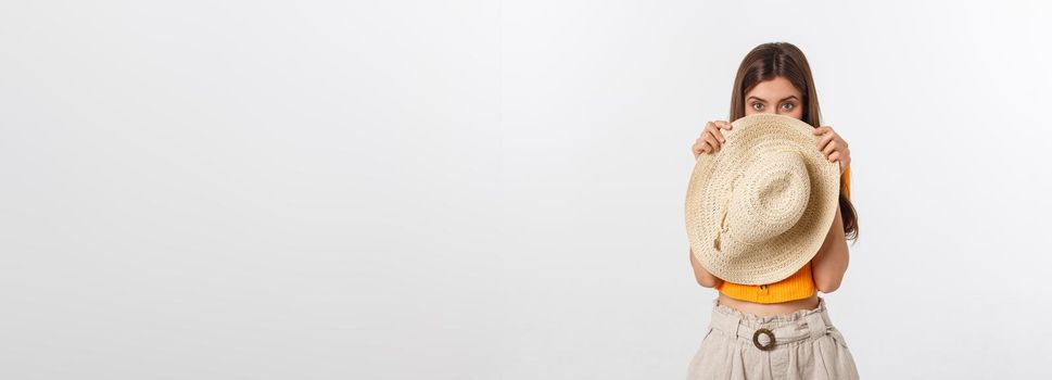 Flirty funky caucasian woman hiding behind fashionable trendy red head wear, with wide open eyes.