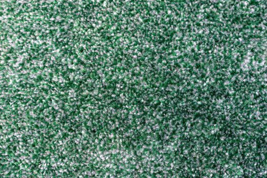 Green carpet texture background closeup view