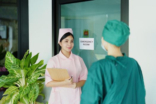 Portrait of doctor and nurse talking to prepare before going to the emergency room to treat patients.