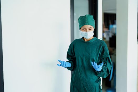 Portrait of a doctor wearing gloves before entering the operating room.