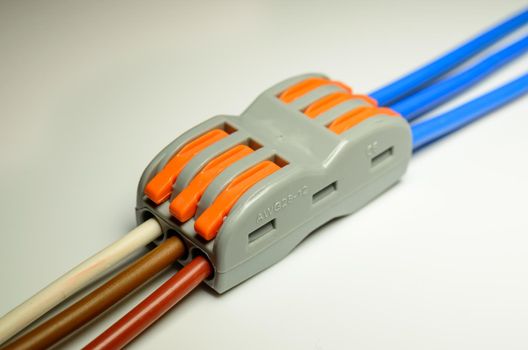 Electrical terminal for quick connection of wires with connected colored mounting wires - macro photo. High quality photo