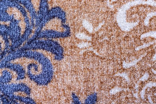 Light brown color carpet with blue and white color design texture background closeup view