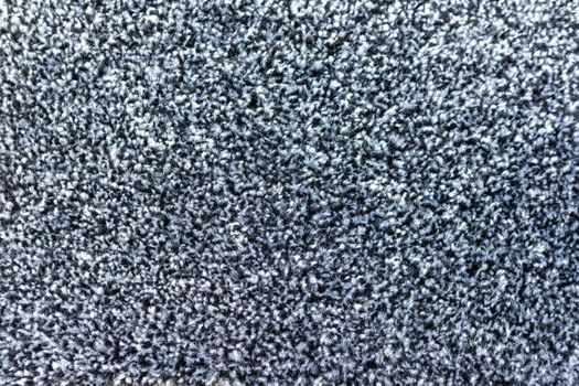 Black and grey carpet texture background closeup view