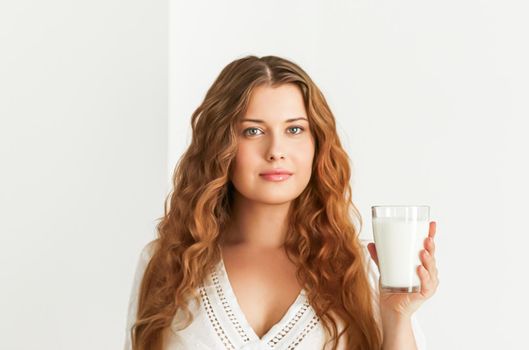 Diet, health and wellness concept, woman holding glass of milk or protein shake cocktail