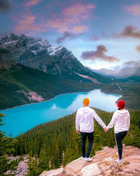 Lake Peyto in Banff National Park, Canada. Mountain Lake as a fox head is popular among tourists in Canada driving the icefields parkway. A couple of men and women looking out over the lake