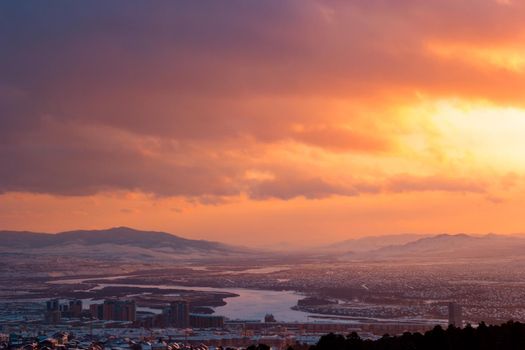 Red purple beautiful dramatic landscape, yellow magenta sunset in urban valley with river and mountain range, scenic dark view of bright night twilight panorama