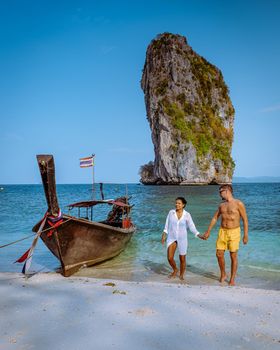 Koh Poda Island Krabi Thailand, couple mid age Asian woman and a European man on the beach, Koh Poda Thailand, the beautiful tropical beach of Koh Poda, Poda Island in Krabi province