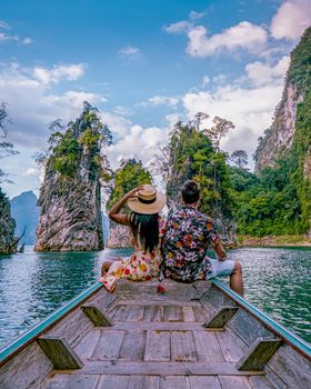 couple on longtail boat visiting Khao Sok national park in Phangnga Thailand, Khao Sok National Park with longtail boat for travelers, Cheow Lan lake, Ratchaphapha dam. man and woman mid age vacation