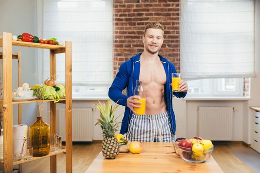 Close up photo Body part young athletic athletic fitness handsome man drinking fresh orange juice from glass in kitchen at home in casual clothing