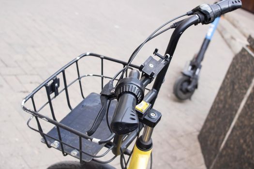 Handlebar and bicycle basket on the road close up
