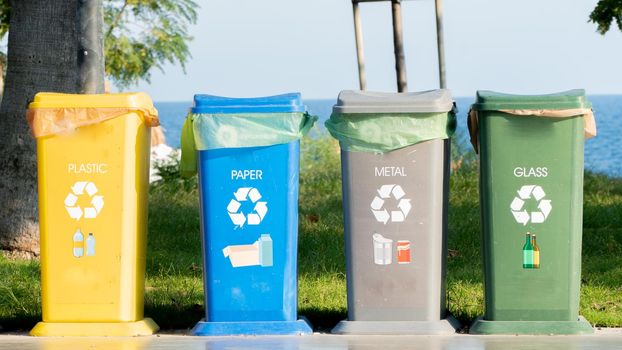 Separate waste collection - waste bins for plastic, glass, paper and metal. High quality photo