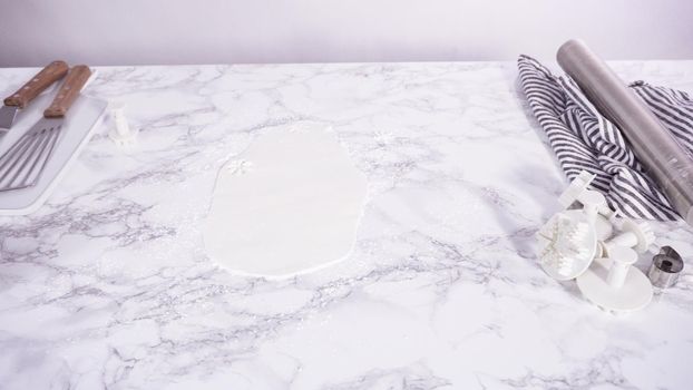 Step by step. Rolling our white fondant on a marble counter.