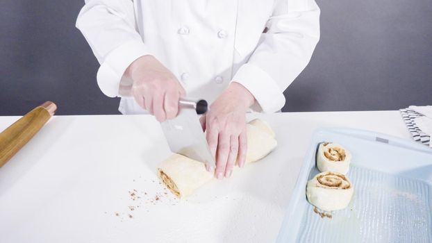 Rolling dough with a french rolling pin to bake cinnamon rolls.