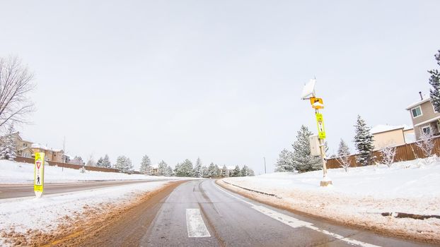 Driving on typical paved roads in a suburban upscale residential neighborhood of America.