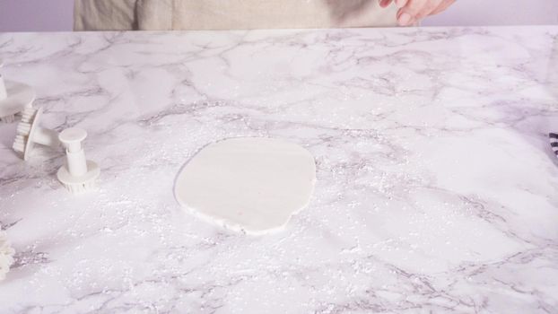 Step by step. Rolling our white fondant on a marble counter.