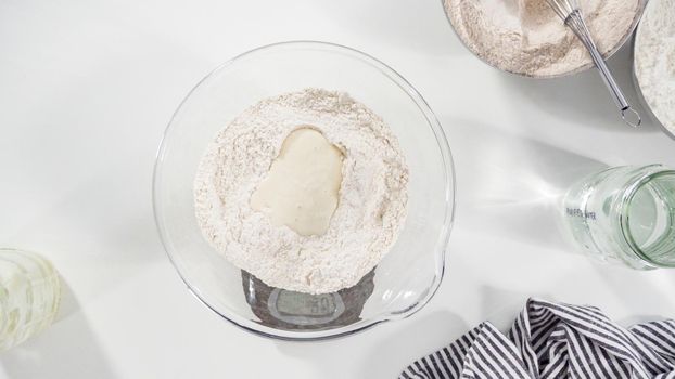 Flat lay. Measuring ingredients into a glass bowl to bake cinnamon rolls.