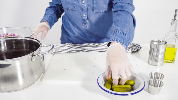 Step by step. Cutting cookies vegetables on a white cutting board for vinaigrette salad.