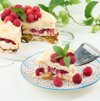 Round meringue pie with fresh raspberries on a white background, Pavlova dessert