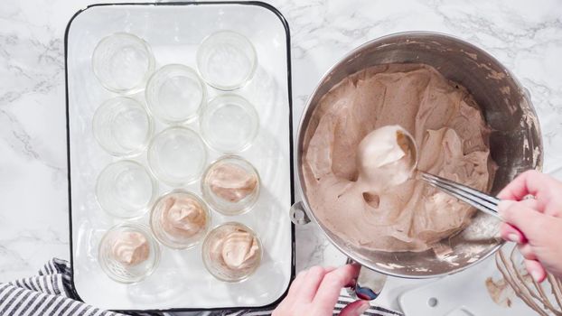 Flat lay. Step by step. Scooping homemade chocolate ice cream into glass jars.