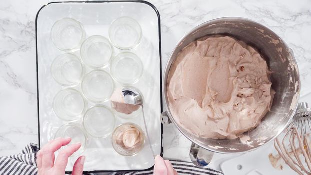 Flat lay. Step by step. Scooping homemade chocolate ice cream into glass jars.