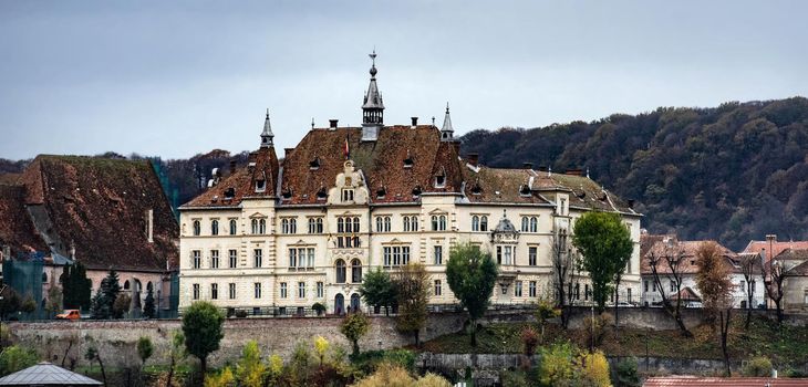 Ancient Sighisoara city in Romania, panoramic clock tower and medieval castle view. Historic european town with heritage and motherland of Dracula