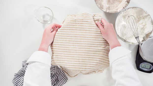 Flat lay. Knitting dough by hand to bake cinnamon rolls.