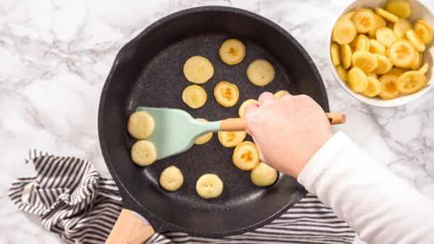Flat lay. Step by step. Frying mini pancake cereal in a nonstick frying pan.