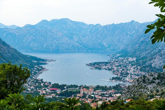 Panorama of Kotor bay and city in Montenegro with aerial view from mountain. Scenic landscape with town and Adriatic sea