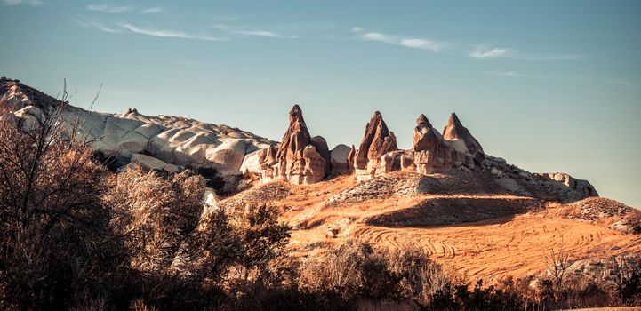 Unusual rocky mountains on sky background in Cappadocia, Turkey