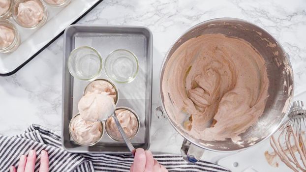 Flat lay. Step by step. Scooping homemade chocolate ice cream into glass jars.